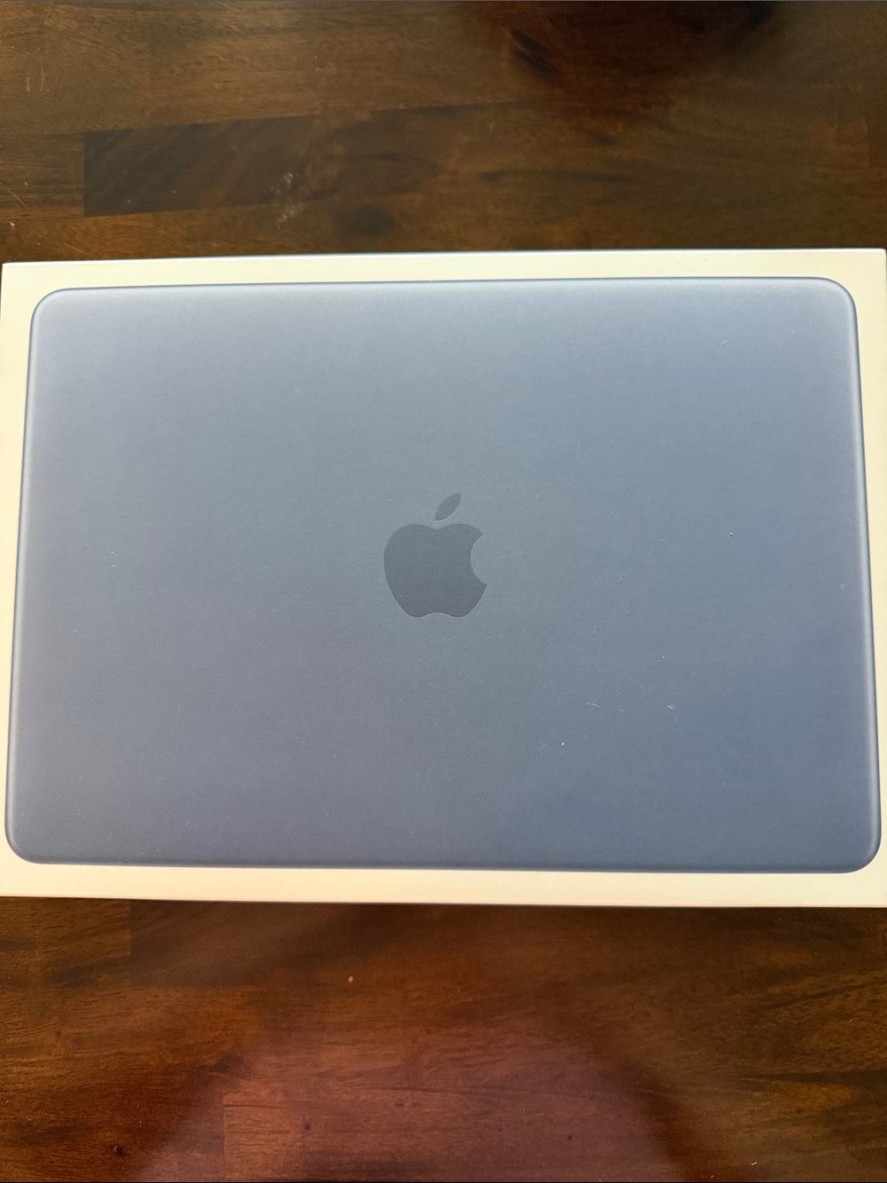 Paper box of the Apple MacBook in Light Blue with Apple Logo